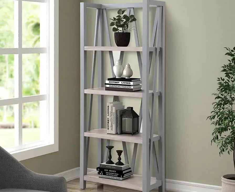 Modern gray bookshelf with decorative items by window.