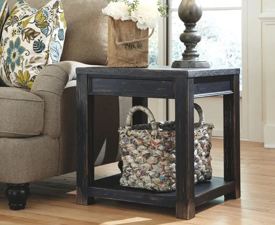 Rustic end table with flowers beside sofa.