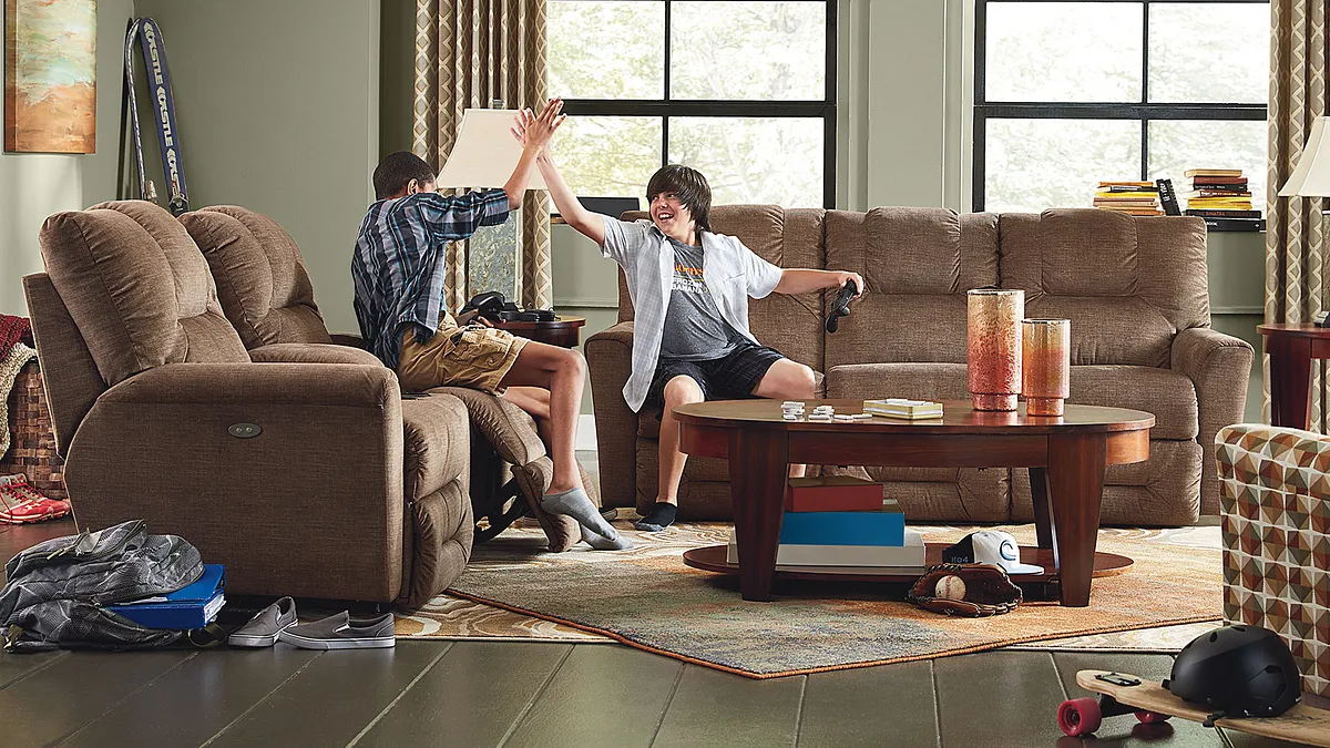 La-Z-Boy Reclining Sofa and Loveseat with two boys playing games and high fiving